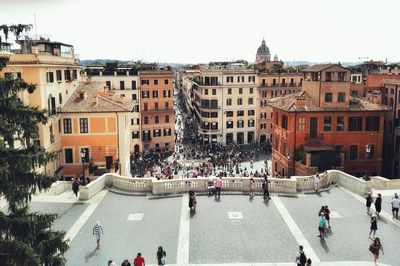 High angle view of people on road amidst buildings in city