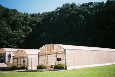 Built structure on field against trees