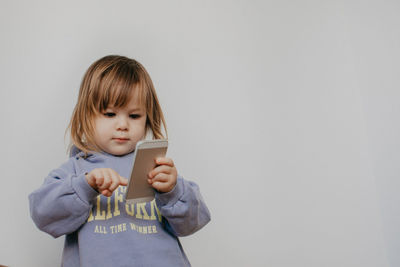 Portrait of cute girl against white background