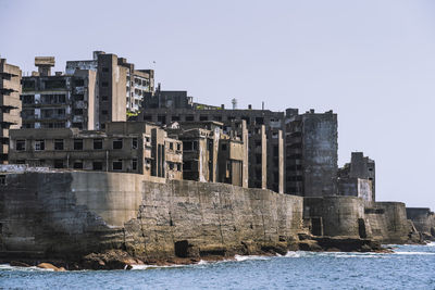 Buildings in city against clear sky