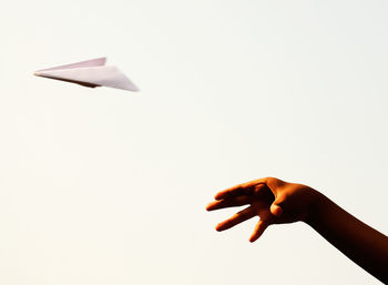 Cropped image of hand holding over white background
