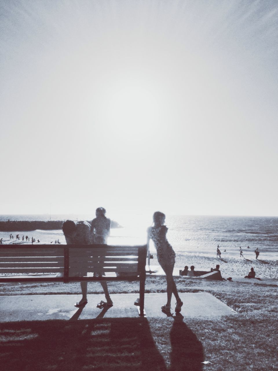 water, sea, lifestyles, clear sky, full length, leisure activity, rear view, horizon over water, men, standing, person, beach, copy space, railing, togetherness, walking, shore, nature