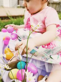 Cute girl on easter playing with easter eggs 