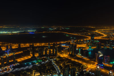 Aerial view of illuminated city buildings at night