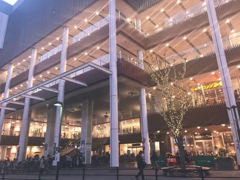 People in illuminated building at night