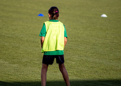 Rear view of girl standing on land