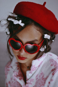 Close-up of girl wearing sunglasses at home