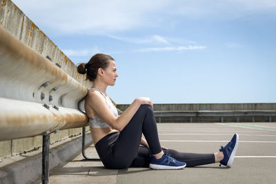 Sport and lifestyle concept - woman resting after doing sports outdoors