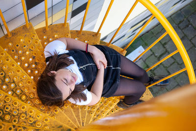 High angle portrait of woman lying staircase