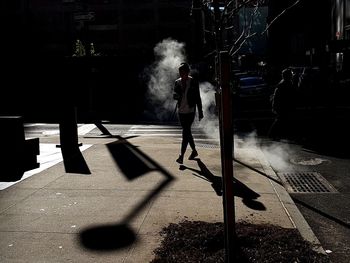 Man with arms raised in city