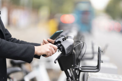 Midsection of man holding bicycle