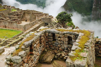 High angle view of built structures at machu picchu in foggy weather