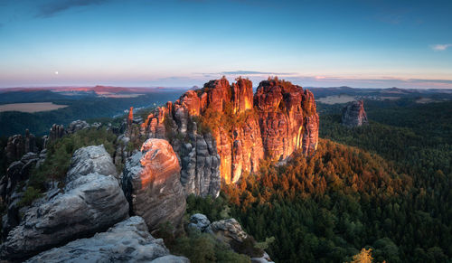 Rock formations against sky during sunset