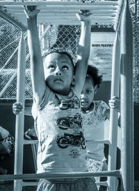 Boy playing with sister outdoors