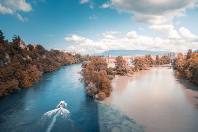 High angle view of river amidst trees against sky