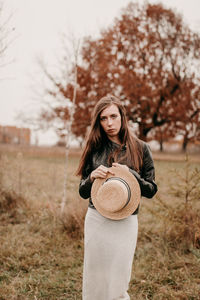 Sad girl with a hat. portrait of a girl in brown tones. walk through the woods. autumn colors. 