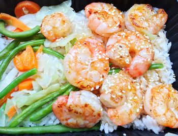 High angle view of prawns with rice in box