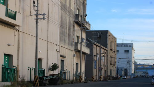 Street amidst buildings in city against sky