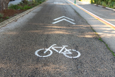 High angle view of arrow symbol on road in city