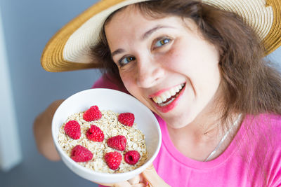 Portrait of woman holding breakfast in bowl