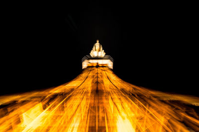 Low angle view of illuminated built structure at night