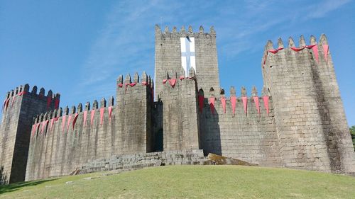 Low angle view of guimaraes castle against sky