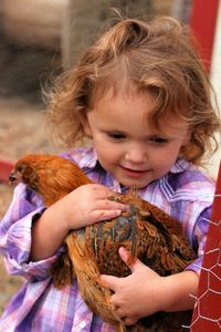 Close-up of a girl holding a bird