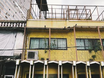 Low angle view of yellow building against sky