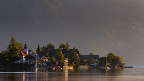 View of building by river against sky