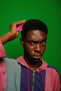 Portrait of young man against blue background