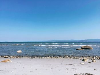 Scenic view of sea against clear blue sky