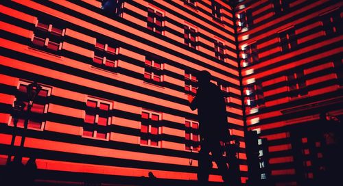 Low angle view of silhouette text on illuminated building at night