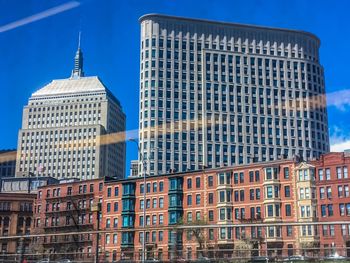 Low angle view of buildings against blue sky