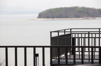 Railings at balcony against sea