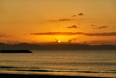 Scenic view of sea against romantic sky at sunset