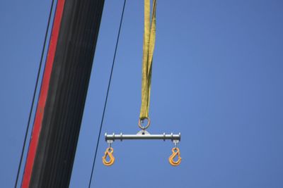 Low angle view of sailboat against clear blue sky