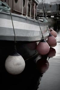 Close-up of rope tied to boat moored at shore