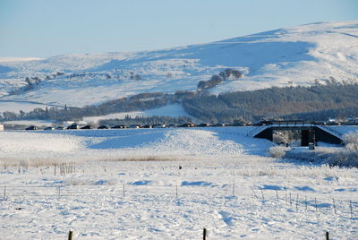 Scenic view of frozen landscape against sky