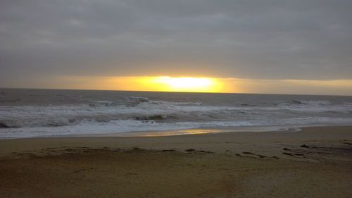 Scenic view of beach against sky during sunset