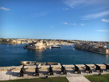 Panoramic view of sea and city against sky