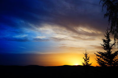 Scenic view of silhouette landscape against sky at sunset