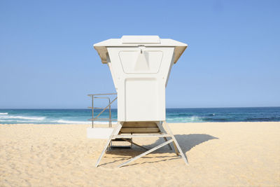 Lifeguard hut on beach against clear sky