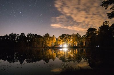 Scenic view of lake against sky at night