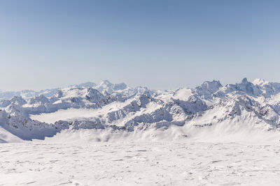 Scenic view of snow covered mountains against sky