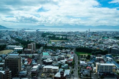 High angle view of city against cloudy sky