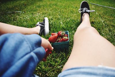 Low section of people relaxing on field