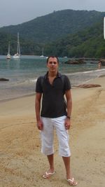 Young man standing on beach