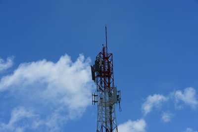 Low angle view of communications tower against blue sky