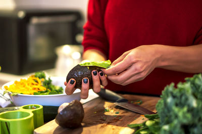 Latin woman cooking a salad for her diet