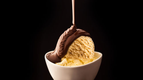 Close-up of dessert in bowl against black background